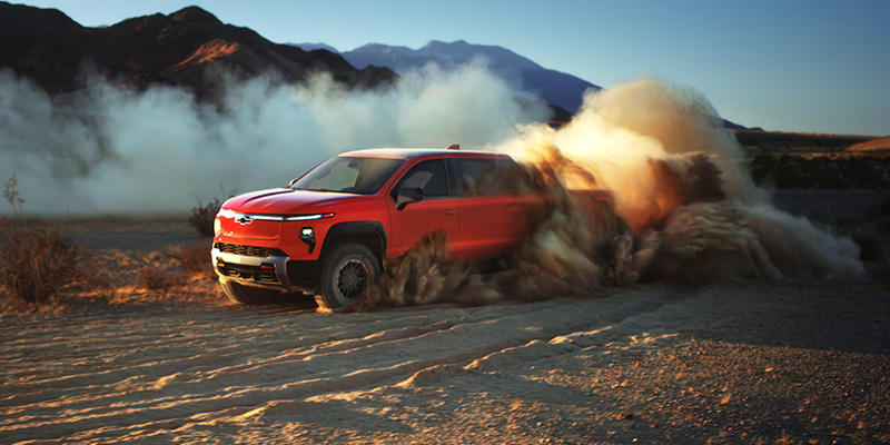 Driving through a desert landscape, showcasing the 2026 Silverado EV in Timonium, MD.