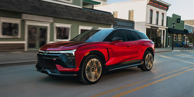 A 2026 Chevrolet Trailblazer drives down a city street in Timonium, Maryland, showcasing its sleek design and urban setting.