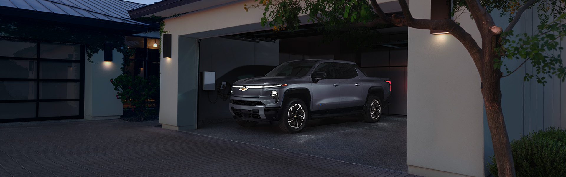 A 2026 Chevrolet Silverado EV parked in a modern garage with soft lighting.
